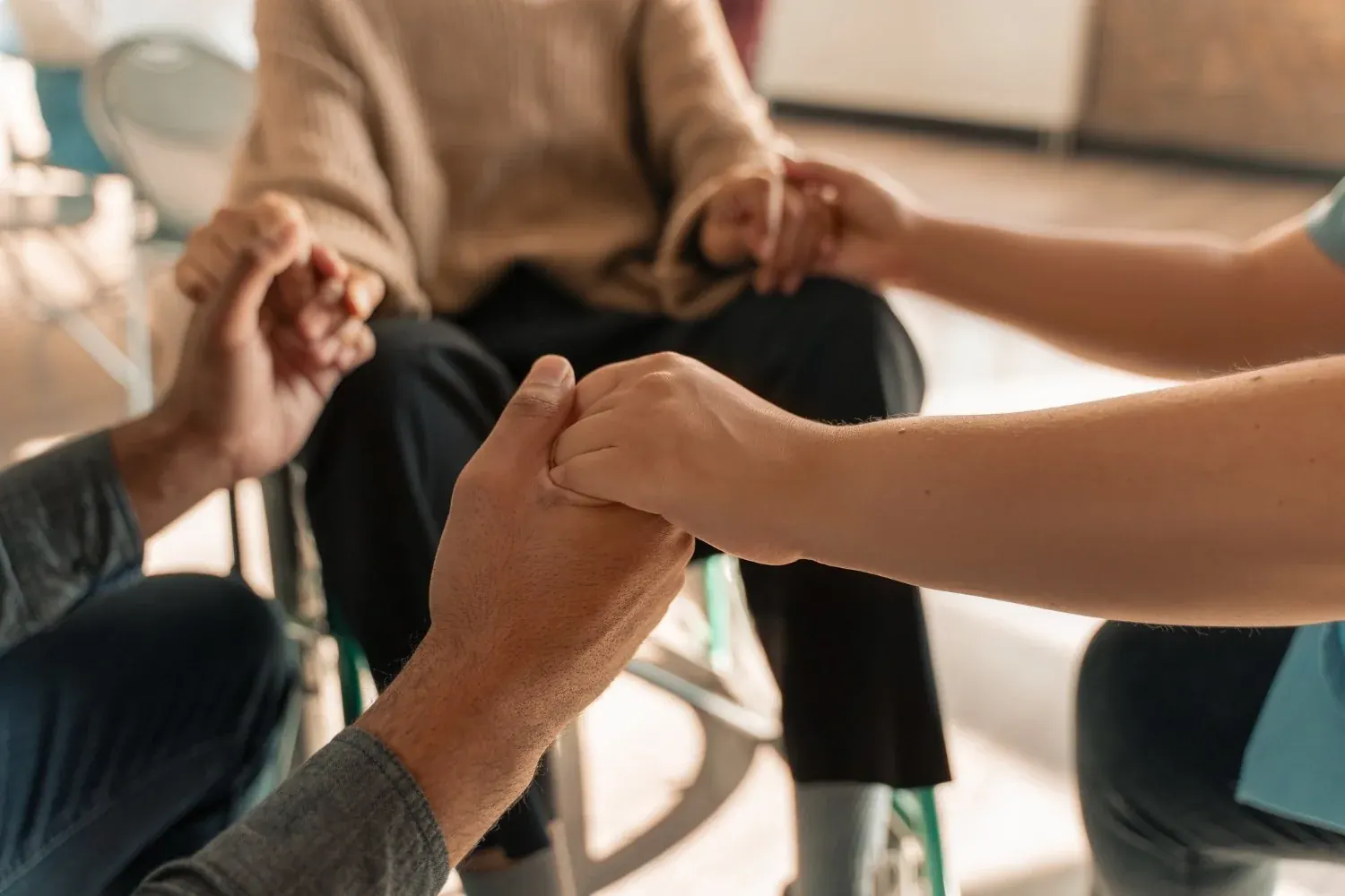 People holding hands in a circle